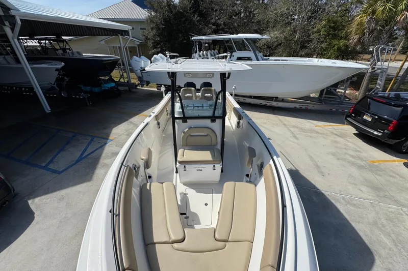 Slide: The Image of 2019 Sailfish 270 CC boat with beige seating, parked in a marina. - 19