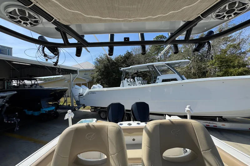 Slide: The Image of 2019 Sailfish 270 CC boat in storage, viewed from the interior with seating and canopy. - 26