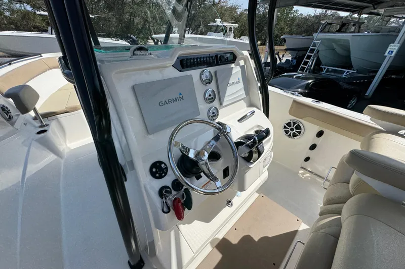 Slide: The Image of 2019 Sailfish 270 CC boat dashboard with Garmin navigation system and steering wheel. - 27