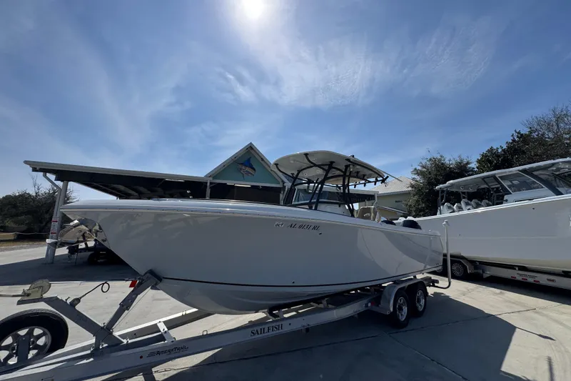 Slide: The Image of 2019 Sailfish 270 CC boat on trailer under clear sky. - 3