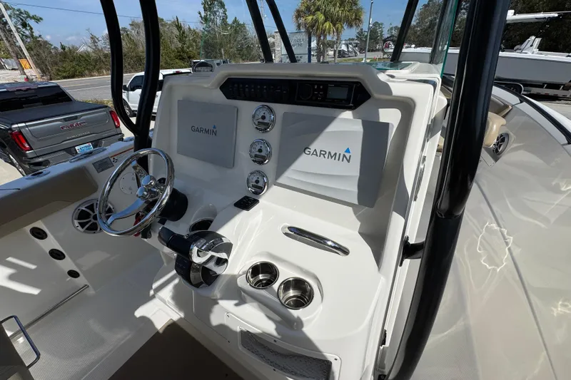 Slide: The Image of 2019 Sailfish 270 CC boat dashboard with Garmin navigation system and steering wheel. - 30