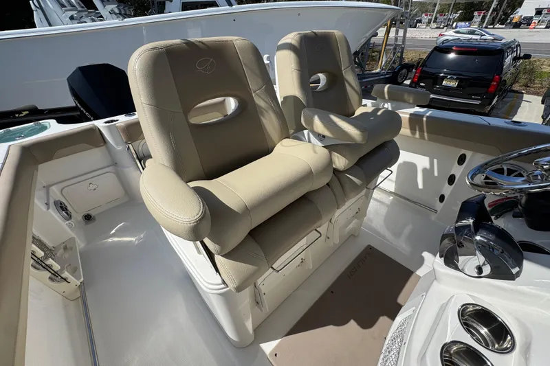 Slide: The Image of 2019 Sailfish 270 CC boat interior with beige captain seats and steering wheel. - 31