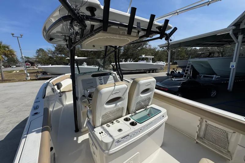 Slide: The Image of 2019 Sailfish 270 CC boat interior with helm, seats, and fishing rod holders. - 32
