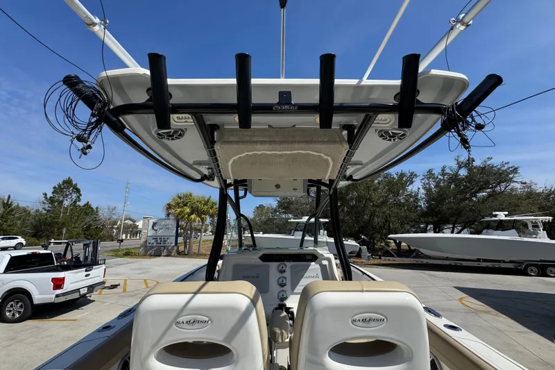Slide: The Image of 2019 Sailfish 270 CC boat interior with rod holders and Garmin electronics. - 34