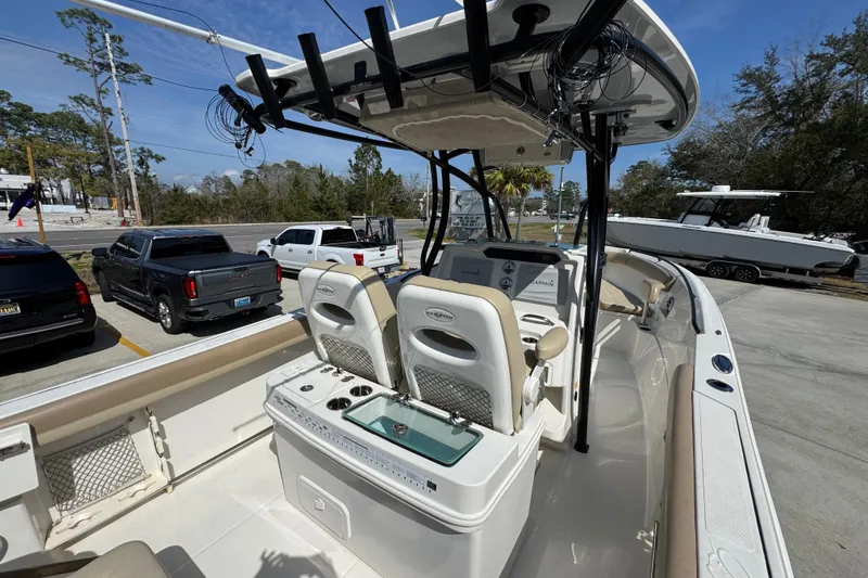 Slide: The Image of 2019 Sailfish 270 CC boat interior with dual seats and fishing rod holders. - 35