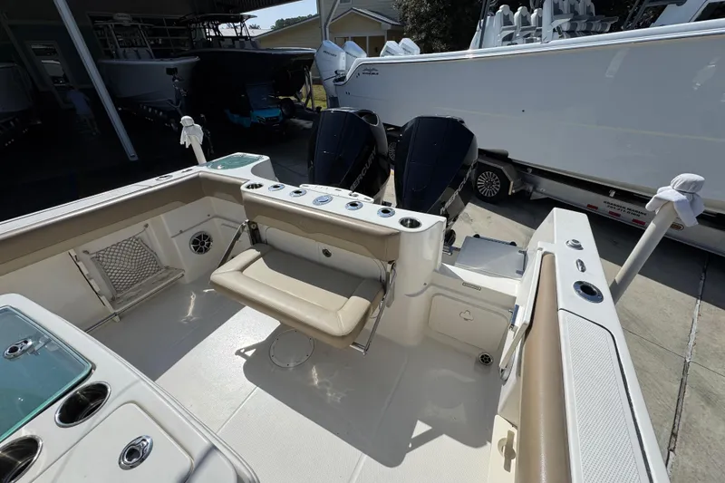 Slide: The Image of 2019 Sailfish 270 CC boat interior with seating and dual outboard motors. - 37