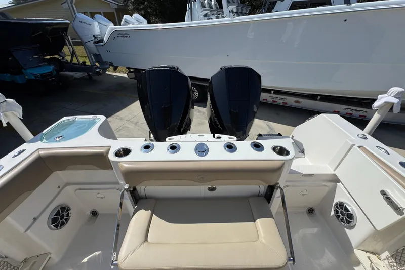 Slide: The Image of 2019 Sailfish 270 CC boat with dual outboard motors and spacious seating area. - 38