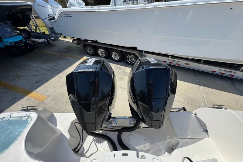 Slide: The Image of 2019 Sailfish 270 CC boat with dual Mercury outboard engines, docked on a trailer. - 39