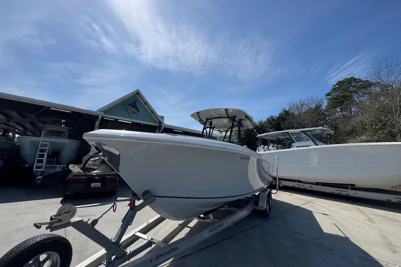 Slide: The Image of 2019 Sailfish 270 CC boat on trailer under clear blue sky. - 4