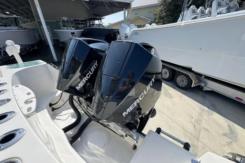 Slide: The Image of 2019 Sailfish 270 CC with dual Mercury outboard engines in a boatyard setting. - 40