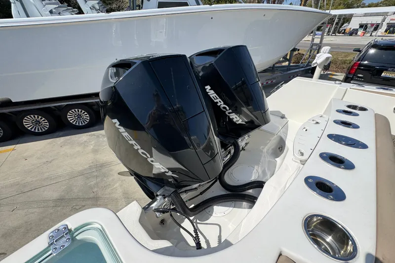 Slide: The Image of 2019 Sailfish 270 CC boat with dual Mercury outboard engines, docked at a marina. - 41