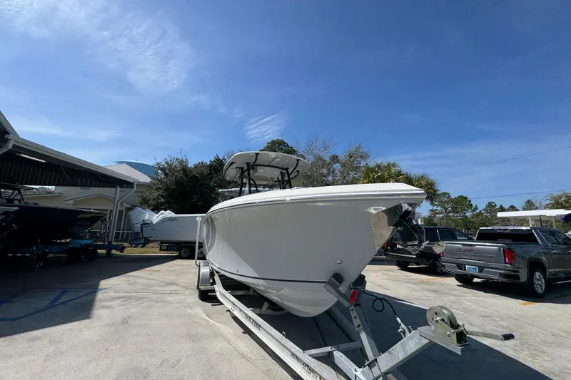 Slide: The Image of 2019 Sailfish 270 CC boat on trailer under clear blue sky. - 6