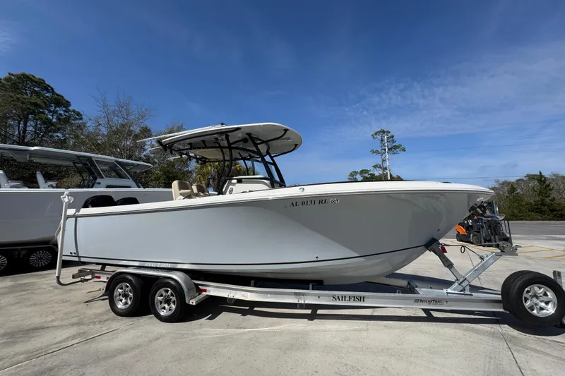 Slide: The Image of 2019 Sailfish 270 CC boat on trailer under clear blue sky. - 8