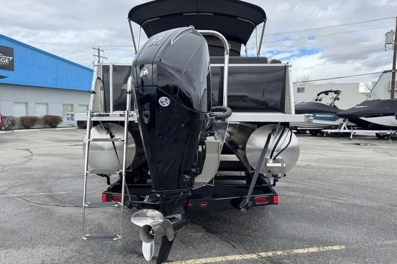 Slide: The Image of 2025 Avalon 2585 25 Catalina ENT pontoon boat with outboard motor, parked outdoors. - 10