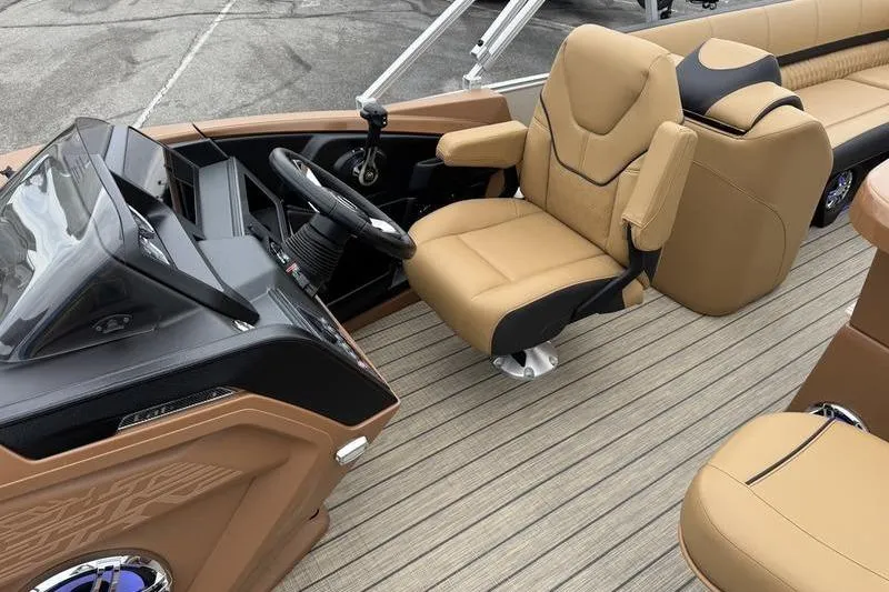 Slide: The Image of 2025 Avalon 2585 25 Catalina ENT boat interior with tan seating and modern dashboard. - 11