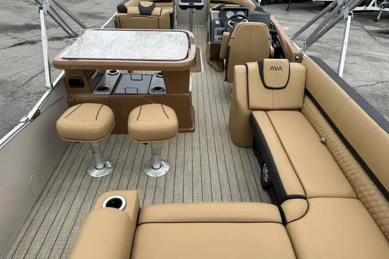 Slide: The Image of Luxurious interior of 2025 Avalon 2585 25 Catalina ENT pontoon boat with tan seating and table. - 13
