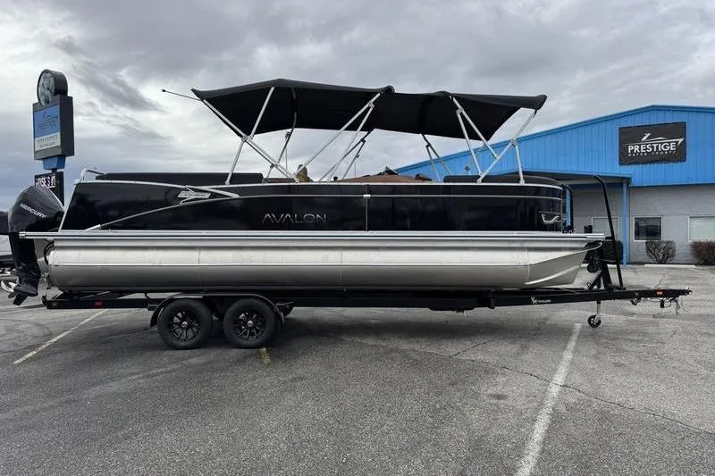 Slide: The Image of 2025 Avalon 2585 25 Catalina ENT pontoon boat on trailer, parked outside dealership. - 4