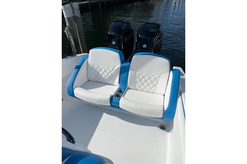 Slide: The Image of 2023 Renegade 32' Cuddy boat with blue and white cushioned seating. - 3