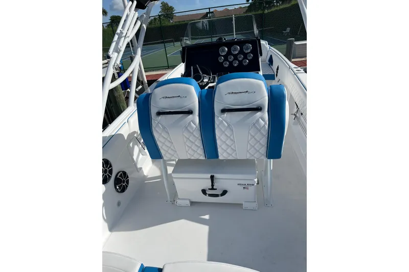 Slide: The Image of 2023 Renegade 32' Cuddy boat interior with blue and white seating, modern dashboard. - 4