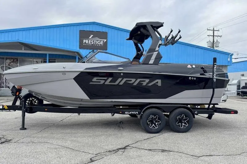 The Image of 2026 Supra SA boat on trailer at Prestige Water Sports dealership. - 1