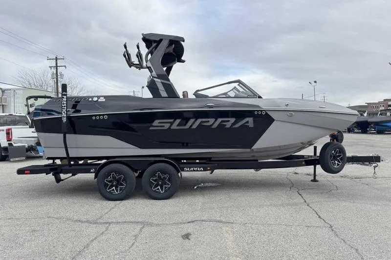 Slide: The Image of 2026 Supra SA boat on trailer, sleek design, black and gray color scheme. - 8