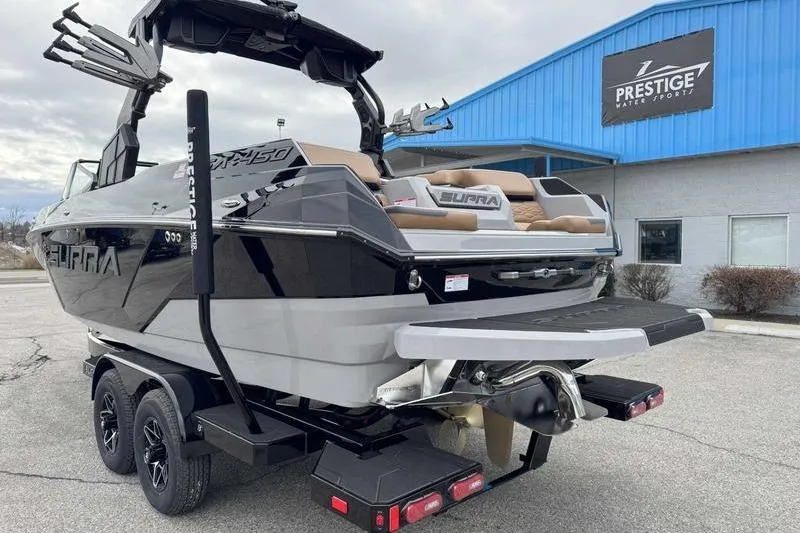 Slide: The Image of 2026 Supra SA boat on trailer at Prestige Water Sports dealership. - 9