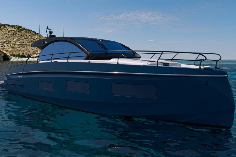 Slide: The Image of 2026 Beneteau Gran Turismo 50 yacht on serene blue waters near rocky coastline. - 20