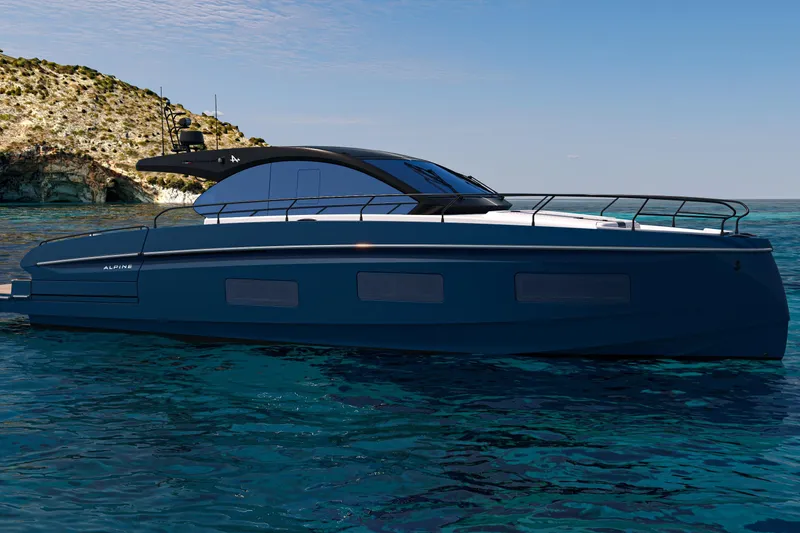 Slide: The Image of 2026 Beneteau Gran Turismo 50 yacht on clear blue water near rocky coastline. - 24