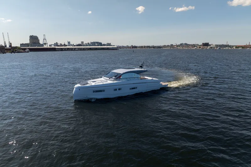 Slide: The Image of 2026 Beneteau Gran Turismo 50 yacht cruising on open water under a clear sky. - 8