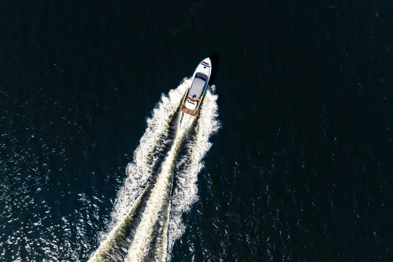 Slide: The Image of Aerial view of 2026 Beneteau Gran Turismo 50 yacht cruising on open water. - 15