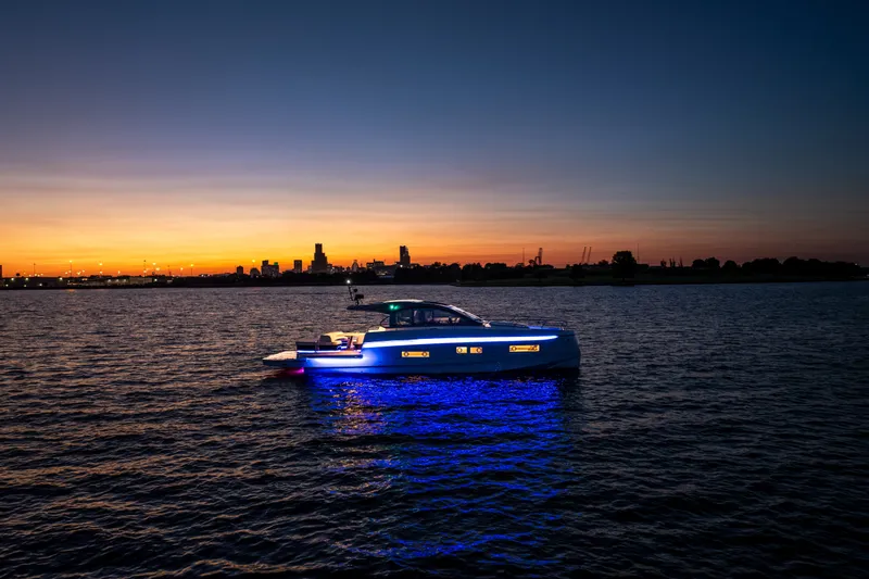 The Image of 2026 Beneteau Gran Turismo 50 yacht illuminated at sunset on calm waters. - 2
