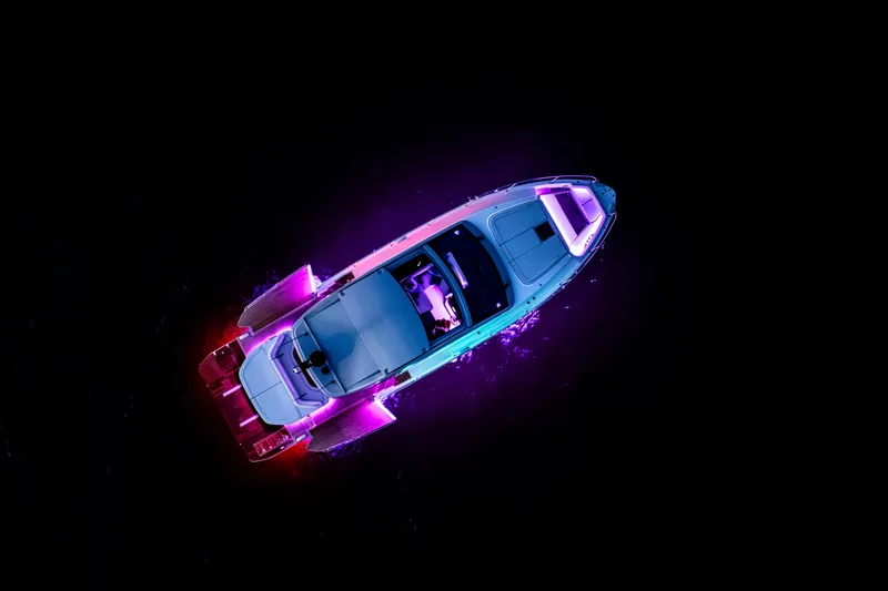 Slide: The Image of Aerial view of 2026 Beneteau Gran Turismo 50 yacht with vibrant neon lights. - 3