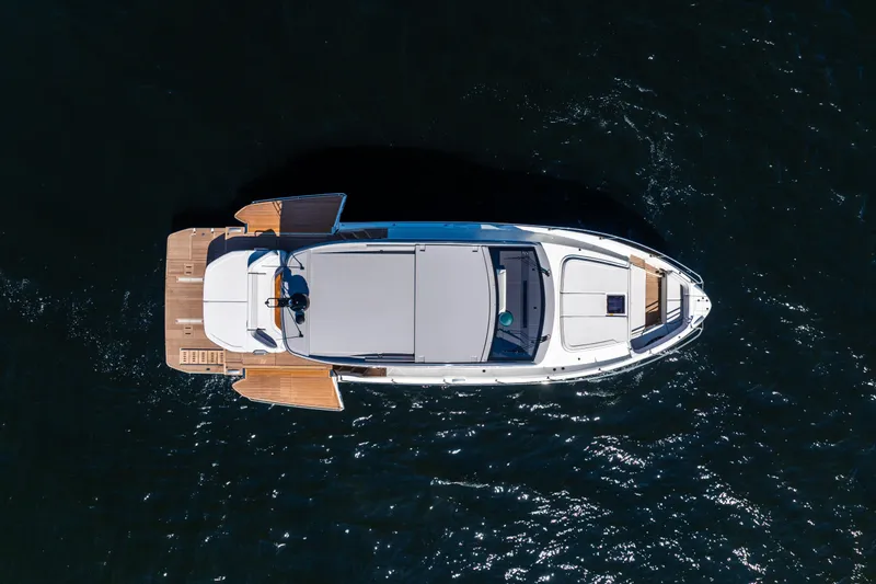 Slide: The Image of Aerial view of 2026 Beneteau Gran Turismo 50 yacht on dark water. - 14