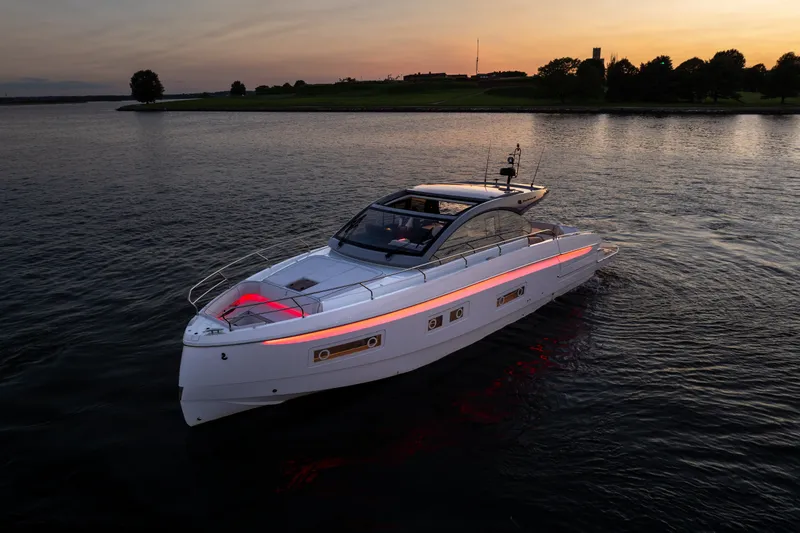 Slide: The Image of 2026 Beneteau Gran Turismo 50 yacht cruising at sunset on calm waters. - 5