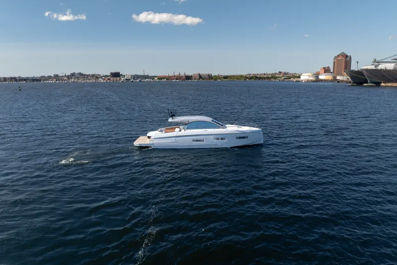 Slide: The Image of 2026 Beneteau Gran Turismo 50 yacht cruising on open water under a clear blue sky. - 7