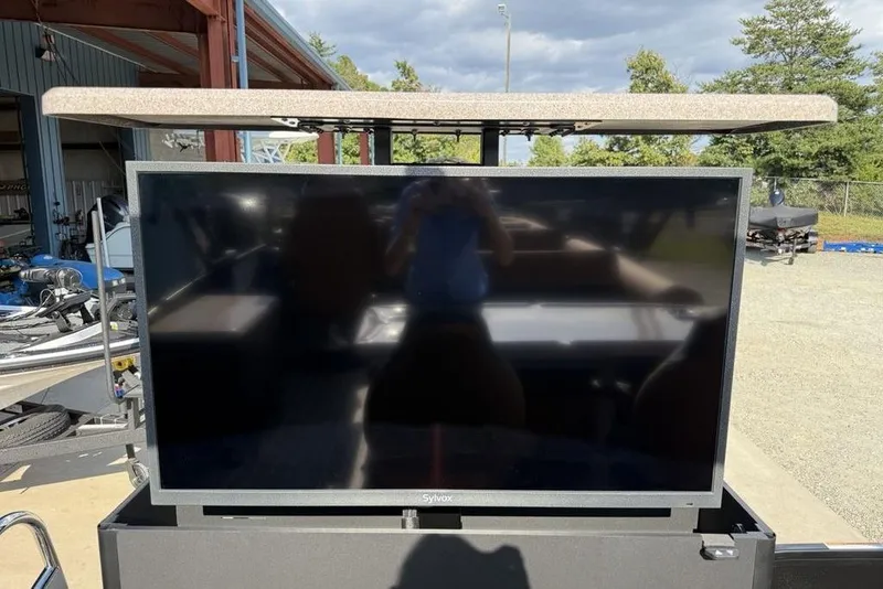 Slide: The Image of Outdoor TV setup on Premier 250 Solaris RF-CL boat, 2026 model, under a canopy. - 37