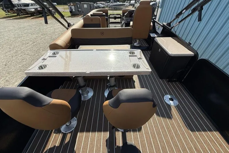 Slide: The Image of 2026 Premier 250 Solaris RF-CL boat interior with seating and table on striped flooring. - 40