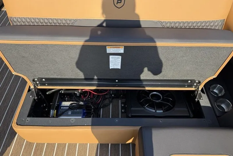 Slide: The Image of Open storage compartment in 2026 Premier 250 Solaris RF -CL boat, revealing wiring and speaker. - 28