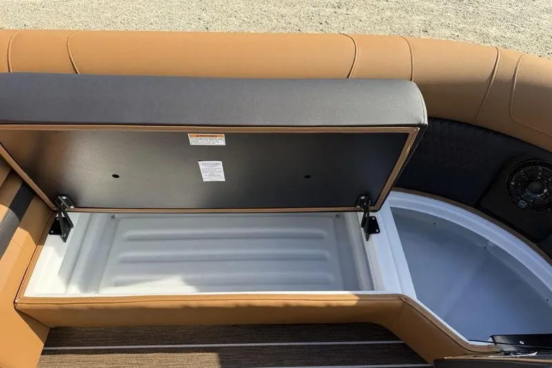 Slide: The Image of Open storage compartment in 2026 Premier 250 Solaris RF -CL boat with tan seating. - 8