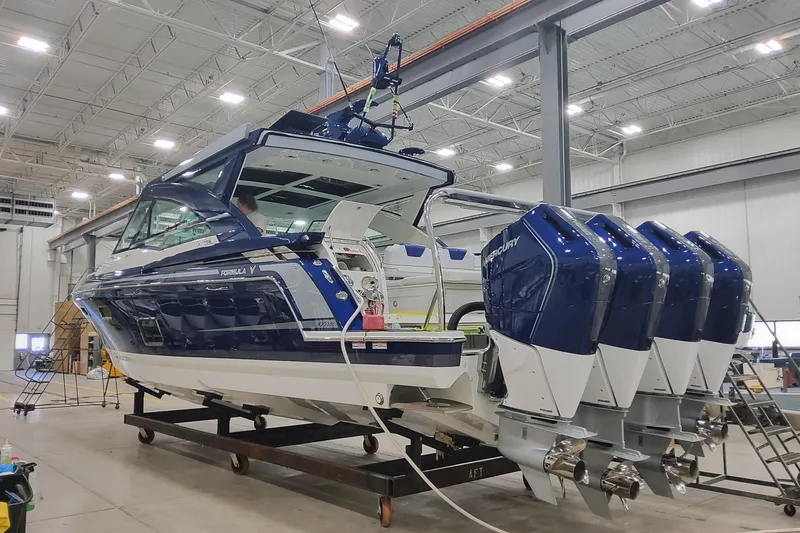 The Image of 2026 Formula 430 Super Sport Crossover boat with four engines in a warehouse setting. - 1