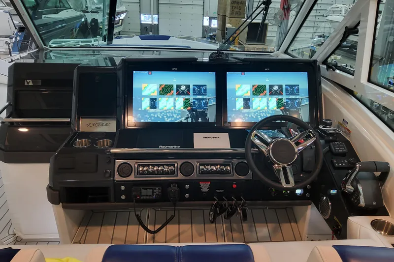 Slide: The Image of Helm of 2026 Formula 430 Super Sport Crossover with dual Raymarine displays and modern controls. - 24
