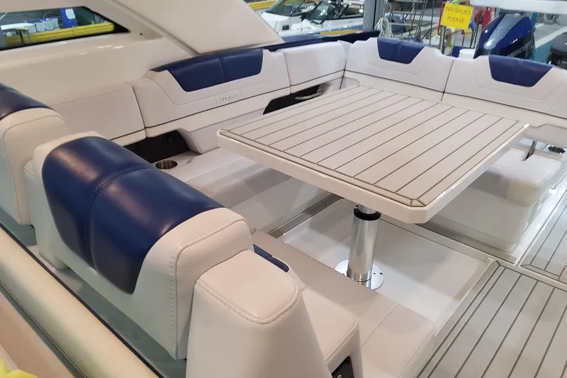 Slide: The Image of 2026 Formula 430 Super Sport Crossover interior with blue and white seating and a central table. - 28