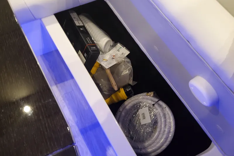 Slide: The Image of Storage compartment in 2026 Formula 430 Super Sport Crossover with hoses and accessories. - 34