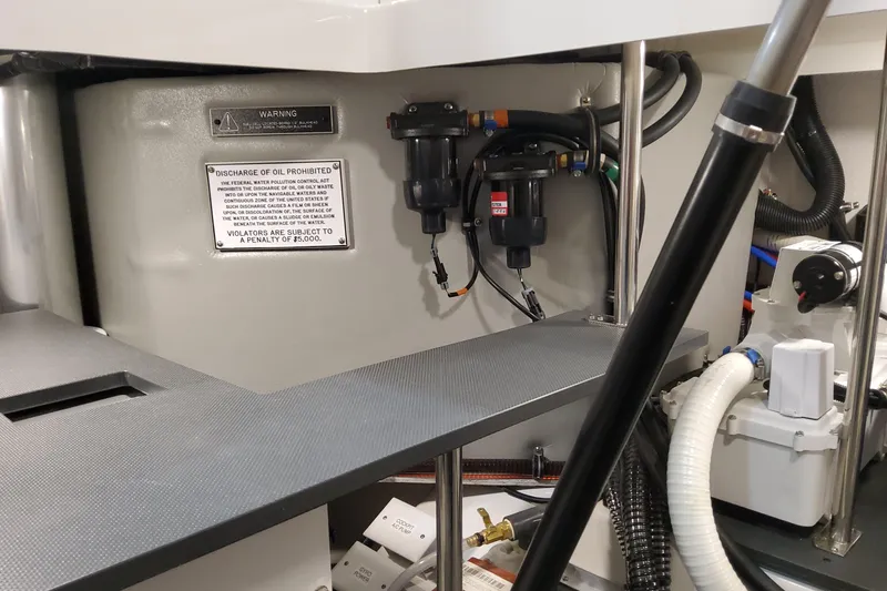 Slide: The Image of Engine compartment of 2026 Formula 430 Super Sport Crossover with warning labels and equipment. - 47