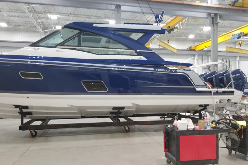 Slide: The Image of 2026 Formula 430 Super Sport Crossover boat in a workshop setting. - 8