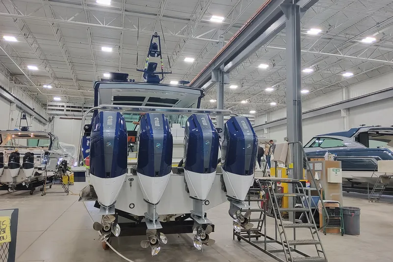 Slide: The Image of 2026 Formula 430 Super Sport Crossover in a boat manufacturing facility, featuring four powerful outboard engines. - 9