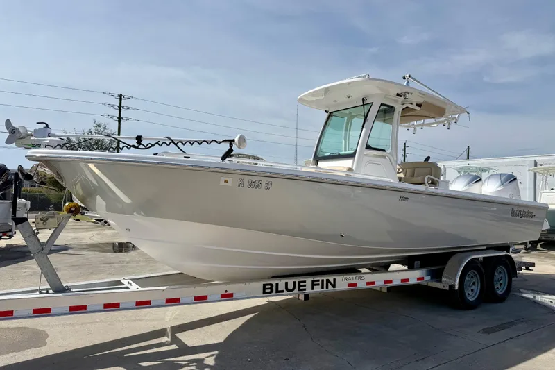 The Image of 2020 Everglades 273 Center Console boat on Blue Fin trailer, parked outdoors. - 1