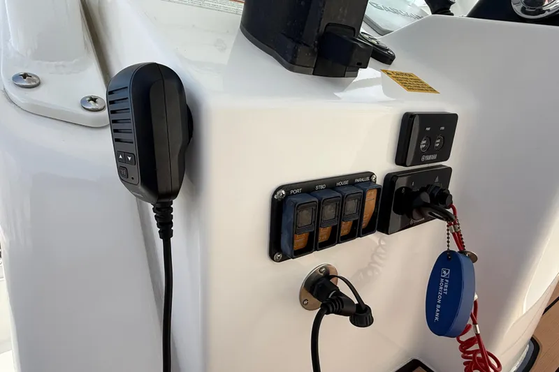 Slide: The Image of Control panel of 2020 Everglades 273 Center Console boat with microphone and switches. - 11