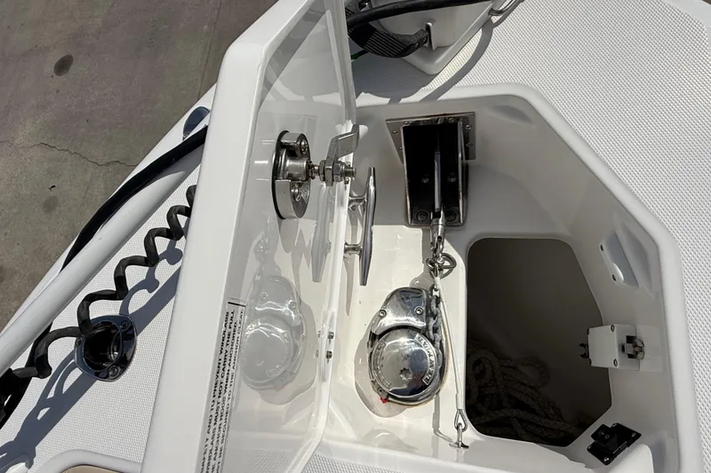Slide: The Image of Anchor compartment of 2020 Everglades 273 Center Console boat, featuring winch and rope storage. - 14
