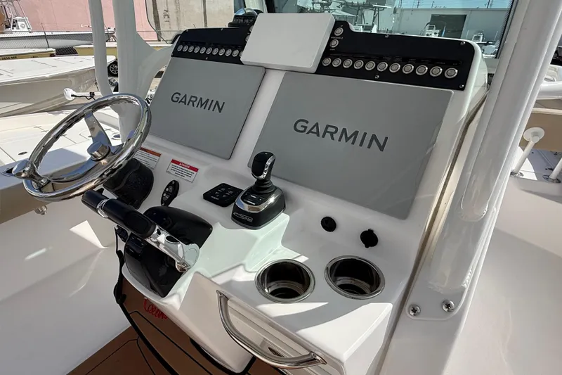 Slide: The Image of 2020 Everglades 273 Center Console boat dashboard with Garmin navigation displays. - 18